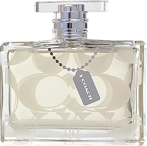 Flacon perfum Coach Signature Woman woda perfumowana damska 100ml na białym tle z eleganckim opakowaniem marki Coach w kolorze złotym